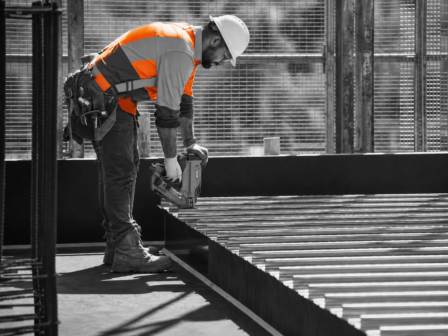 Fixer running a nail gun on a Melbourne build